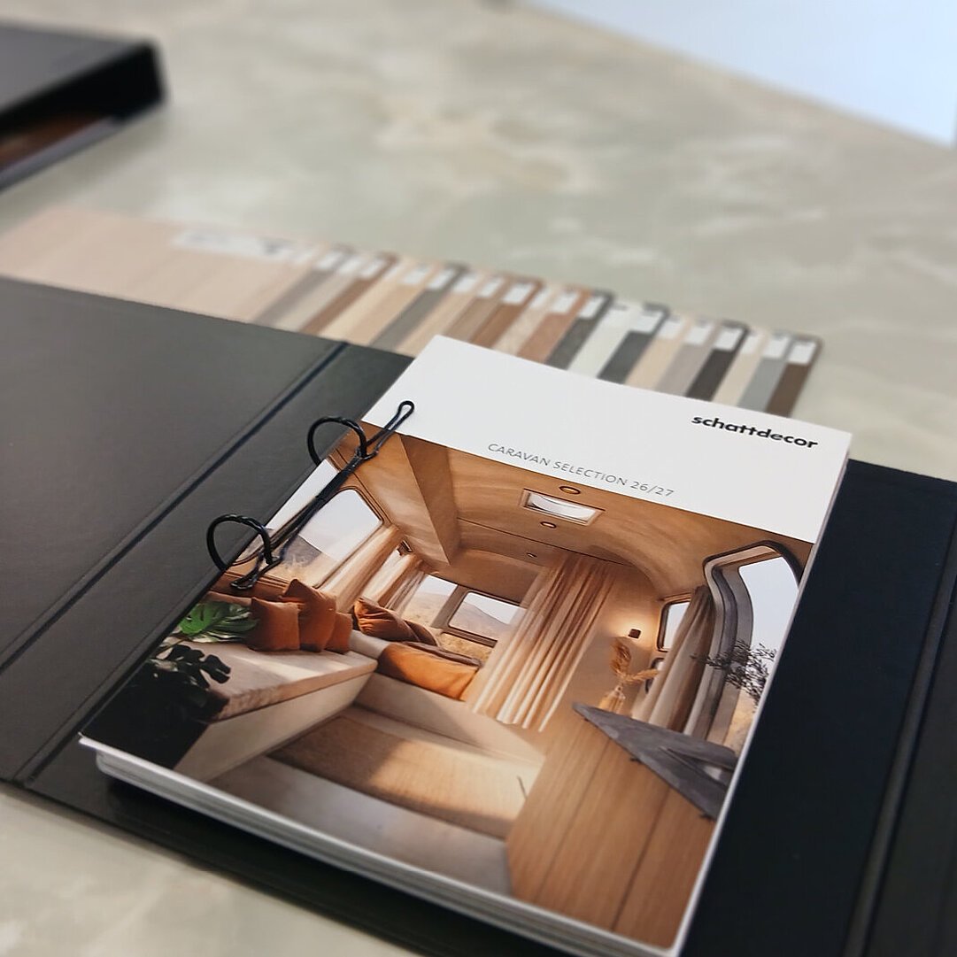 Binder lying on a table showing Caravan interior