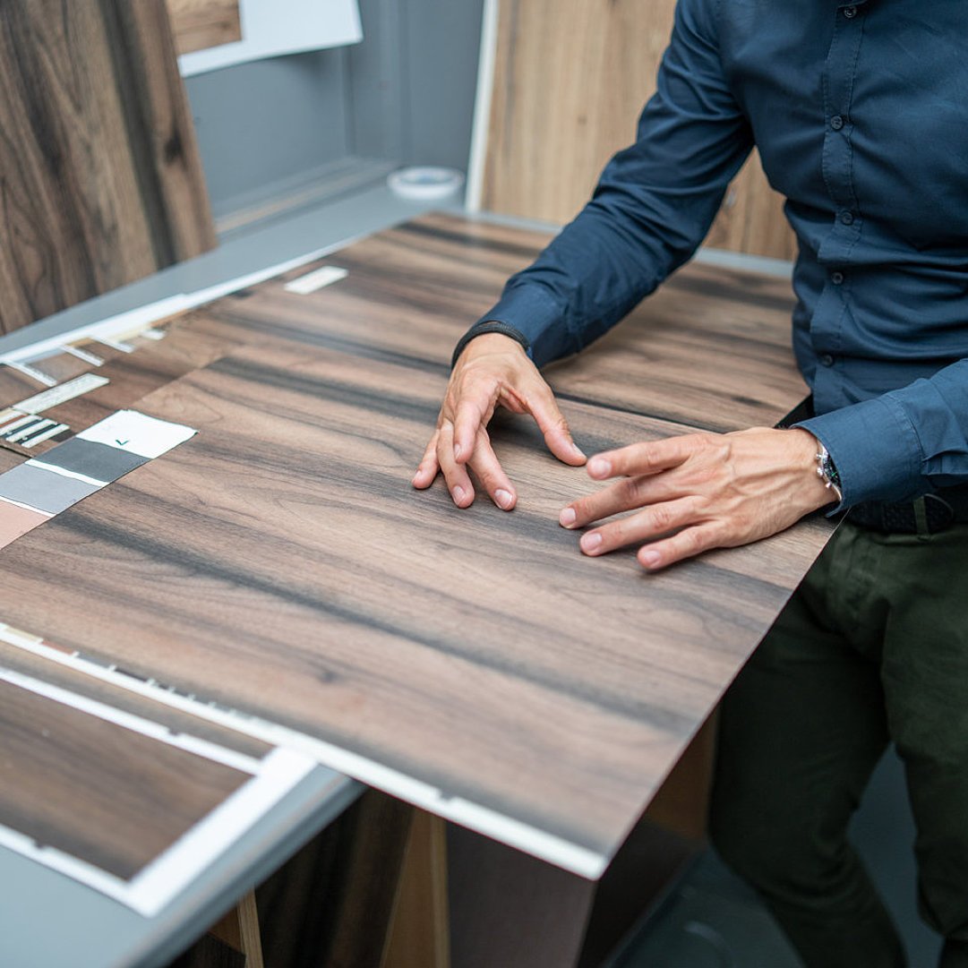 Man showing a section of a decorative pattern with his hands